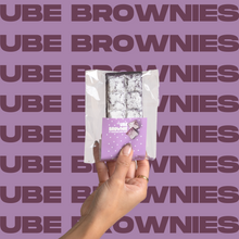 Load image into Gallery viewer, The Ube Brownie being held up in model's hand.