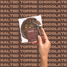 Load image into Gallery viewer, The Salted Toffee Chocolate Cookie being held up by model's hand.