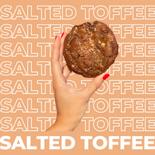 Load image into Gallery viewer, The Salted Toffee Chocolate Cookie being held up by model.
