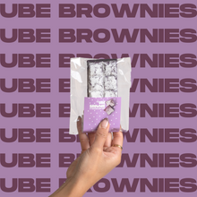 Load image into Gallery viewer, The Ube Brownie being held up in model&#39;s hand.
