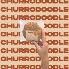 Load image into Gallery viewer, The Churrodoodle Cookie being held up by model&#39;s hand.

