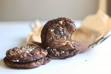 Load image into Gallery viewer, Three Salted Toffee Chocolate cookies placed next to each other. One cookie has a bite taken out of it.
